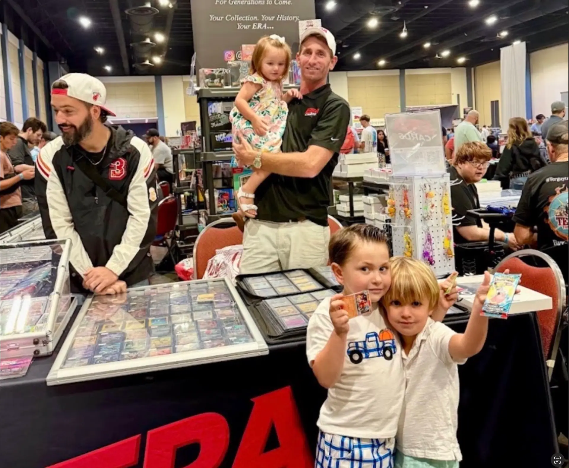 Kids showing off cards they picked up at the ERA Cards table