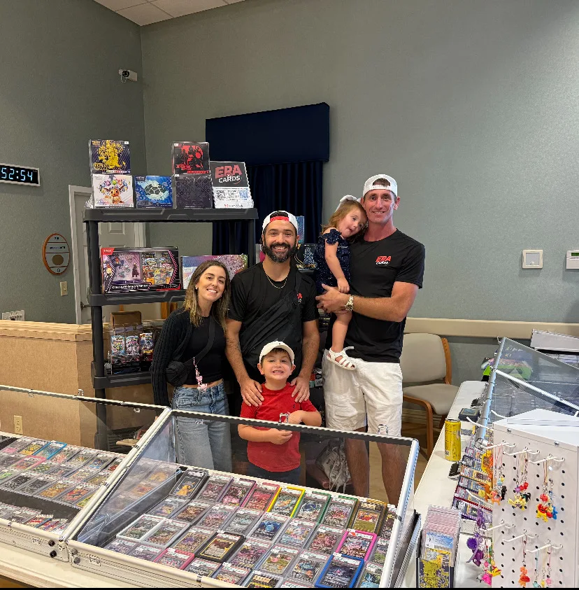 The ERA Cards team behind the display case at a local card show
